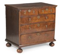 A QUEEN ANNE WALNUT AND CROSSBANDED CHEST OF DRAWERS, CIRCA 1710