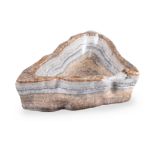 A LARGE BANDED MEXICAN ONYX BOWL OR BIRDBATH OF IRREGULAR TRIFORM, 20TH CENTURY