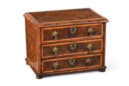 A QUEEN ANNE MINIATURE OLIVEWOOD OYSTER, WALNUT AND HOLLY BANDED CHEST OF DRAWERS, CIRCA 1710