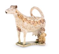 A STAFFORDSHIRE OR SOUTH YORKSHIRE CREAMWARE MODEL OF A COW-CREAMER, CIRCA 1800