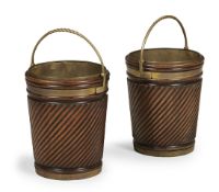 A PAIR OF CARVED MAHOGANY AND BRASS BOUND BUCKETS, IN GEORGE III STYLE, 20TH CENTURY