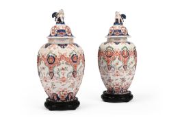 A PAIR OF DELFT POLYCHROME HEXAGONAL SECTION VASES AND COVERS, LATE 19TH CENTURY