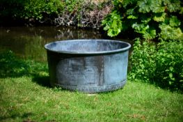 A LARGE PATINATED COPPER AND RIVETED CIRCULAR PLANTER OR WATER FEATURE, CONTEMPORARY