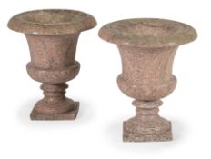 A PAIR OF CARVED PINK GRANITE URNS, 19TH CENTURY
