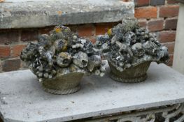 A PAIR OF CARVED LIMESTONE BASKETS OF FRUIT, LATE 18TH OR EARLY 19TH CENTURY