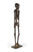 Y AN AFRICAN CARVED MACASSAR EBONY MODEL OF A SKELETON, NIGERIA, 20TH CENTURY