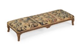 A CARVED BEECH AND TAPESTRY UPHOLSTERED LONG STOOL, IN LOUIS XV STYLE, LATE 19TH CENTURY