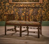 A GEORGE III CARVED MAHOGANY CHAIR BACK SETTEE, IN THE MANNER OF THOMAS CHIPPENDALE, CIRCA 1770