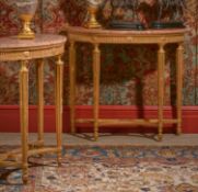 A PAIR OF GEORGE III CARVED GILTWOOD AND MARBLE TOPPED CONSOLE TABLES, CIRCA 1790
