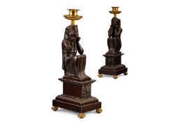A PAIR OF REGENCY GILT AND PATINATED BRONZE NEO-EGYPTIAN CANDLESTICKS