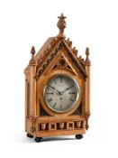 A VICTORIAN GOTHIC REVIVAL CARVED OAK QUARTER-CHIMING BRACKET CLOCK