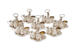 A MATCHED SET OF EIGHT VICTORIAN SILVER FOUR PIECE CRUETS ON STANDS, LONDON 1868 AND 1877
