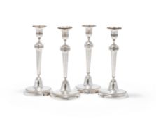 A SET OF FOUR FRENCH EMPIRE SILVER CANDLESTICKS, PARIS, .950 STANDARD, GUARANTEE MARKS 1798 -1809