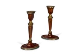 A PAIR OF ORANGE ENAMELED BRASS CANDLESTICKS, INDIAN, EARLY 20TH CENTURY