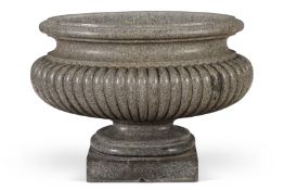 ‡ AFTER THE ANTIQUE - A LARGE ELLIPTICAL CARVED GRANITE CISTERN OR LABRUM