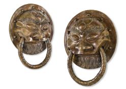 A PAIR OF BRASS TEMPLE DOOR ORNAMENTS, NEPALESE, EARLY 20TH CENTURY