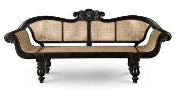 ‡ A CEYLONESE EBONISED HARDWOOD AND CANED SOFA, EARLY 20TH CENTURY