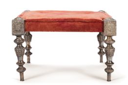 A RAJASTHANI RED VELVET UPHOLSTERED SILVER 'PALACE' STOOL OF LARGE SIZE,