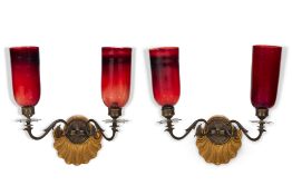 A PAIR OF GILT METAL MOUNTED CARVED GILT PAINTED WOOD, AND RED GLASS TWIN BRANCH WALL LIGHTS