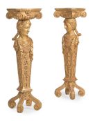 A PAIR OF CARVED GILTWOOD FIGURAL TORCHERES, IN THE MANNER OF WILLIAM KENT, CONTEMPORARY