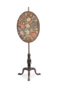 A GEORGE II CARVED MAHOGANY AND NEEDLEWORK MOUNTED POLE SCREEN, IRISH, CIRCA 1750