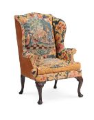 A RARE IRISH GEORGE II MAHOGANY AND NEEDLEWORK WING ARMCHAIR, CIRCA 1730