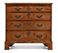 A GEORGE II WALNUT AND FEATHERBANDED BACHELOR'S CHEST OF DRAWERS, CIRCA 1735