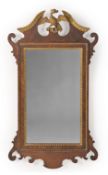 A GEORGE II WALNUT AND PARCEL GILT MIRROR, CIRCA 1740