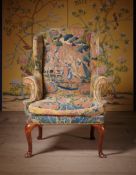 A GEORGE I WALNUT AND NEEDLEWORK WING ARMCHAIR, CIRCA 1720