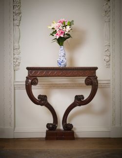 A GEORGE II CARVED MAHOGANY CONSOLE TABLE, IN THE MANNER OF WILLIAM JONES, CIRCA 1755