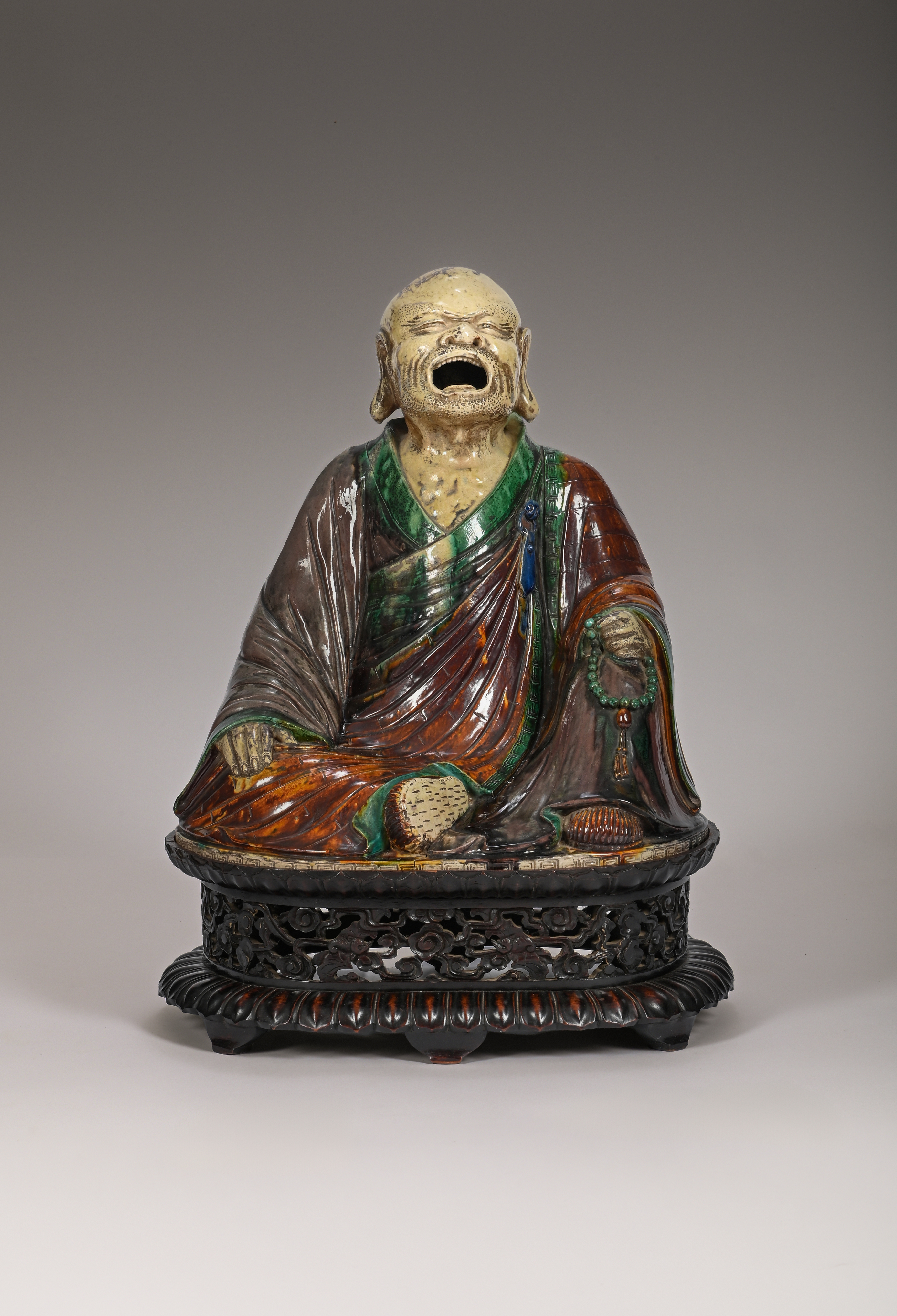 A large and rare Chinese sancai-glazed pottery figure an Arhat, Savaka, 15th -17th century