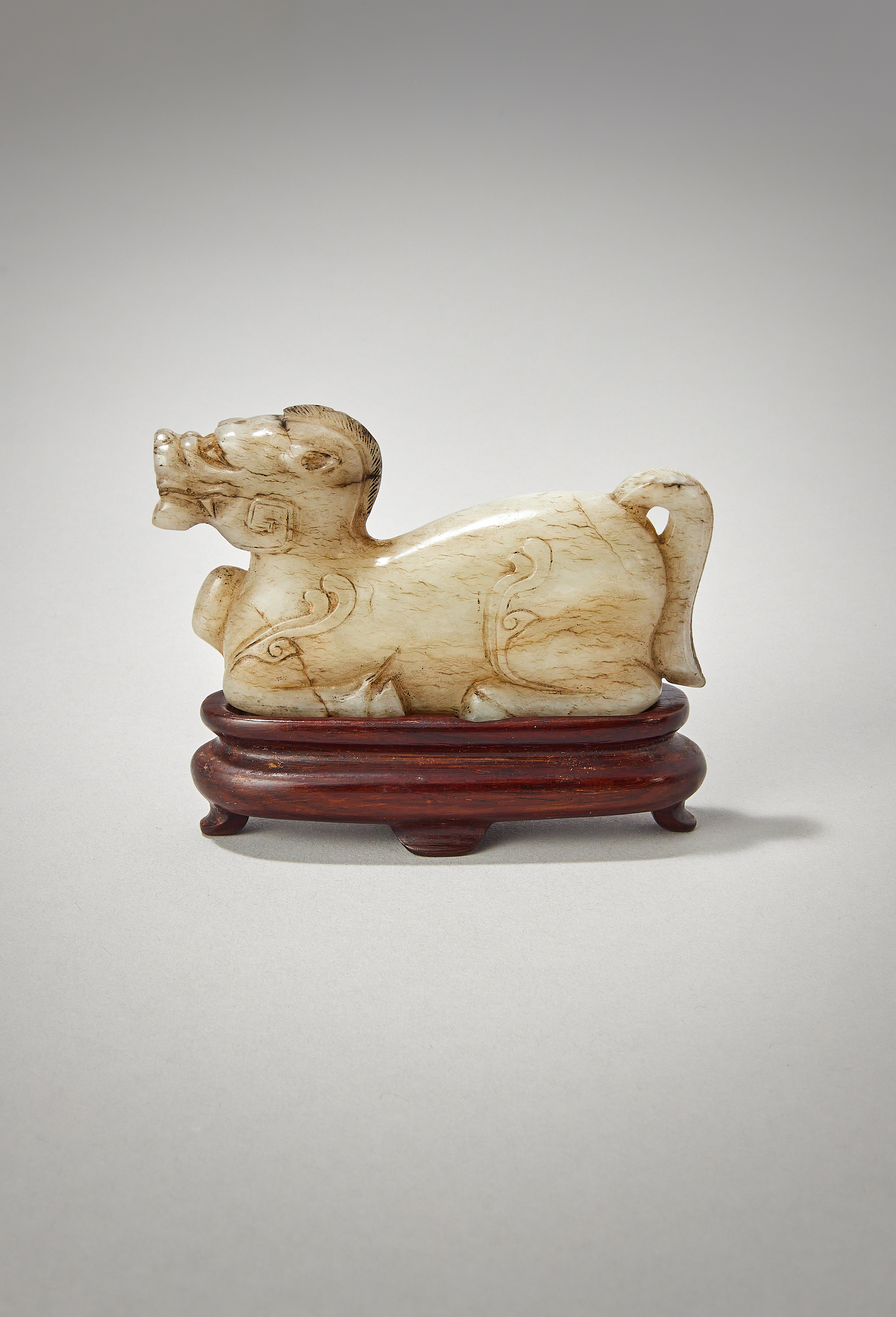 A Chinese white and grey jade carved mythical beast, tianma, Han Dynasty (206 BC-AD 220)