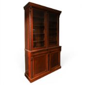 Victorian carved mahogany enclosed bookcase on cupboard