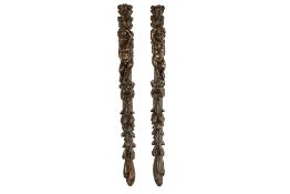 pair of antique wall sculptures in fruitwood, each with a Cupid