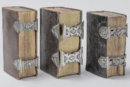 three antique leather bound Bibles each with a double silver lock