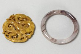 Chinese bracelet in pinkish stone and pendant in ochre-color stone