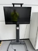Hannspree television with remote, on mobile stand