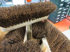 Quantity of hard bristle yard brushes