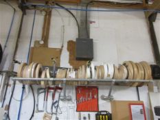 Sixty four small rolls of wood effect edge banding