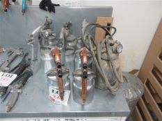 Eight Devil Bliss pneumatic spray guns and one unbranded pneumatic spray gun