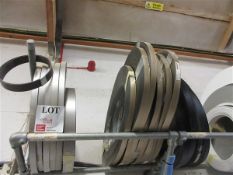 Thirteen various sized bronze brushed edge banding rolls