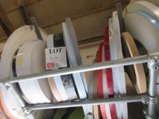 Seventeen various sized and coloured edge banding rolls
