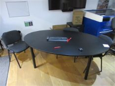 Black oval shaped table, height 730 x length 2000 x width 1200mm, and nine upholstered chairs