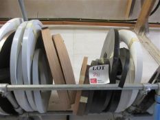 Sixteen various sized and coloured edge banding rolls