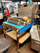 Mobile food production table with incomplete control panel and quantity of metal belt and additional