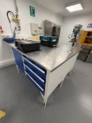 Double width SS work top sitting on opposite benches with drawers and cabinets built in. Includes co