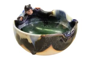 A Japanese Sumida Gawa pottery pond bowl, of irregular circular form, covered in flowing black, blue