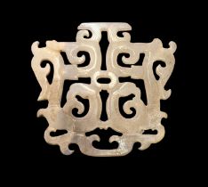 A Chinese white jade openwork plaque, carved to both sides with an archaistic symmetrical