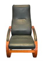 A vintage Verikon ‘Como’ rocking armchair, upholstered in dark green leather with segmented