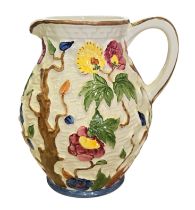 An H. J. Wood Ltd ‘Indian Tree’ pottery jug, of ovoid form, the textured white-glazed body moulded